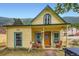 Charming yellow two-story home with a covered porch and mountain views at 400 Argentine St, Georgetown, CO 80444