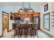 Bright kitchen with brick backsplash, island seating, and stainless steel appliances at 400 Argentine St, Georgetown, CO 80444