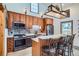 Modern kitchen with stainless steel appliances, wooden cabinets, and an island with seating at 400 Argentine St, Georgetown, CO 80444