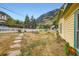 View of the front yard with the home, a picket fence and mountain views at 400 Argentine St, Georgetown, CO 80444