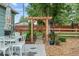 Backyard patio area with a wood pergola, plants, and view of a wooden fence at 247 Tipple Pkwy, Frederick, CO 80530