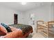 Bedroom with colorful floral bedding, a crib, closet, and neutral walls and flooring at 247 Tipple Pkwy, Frederick, CO 80530