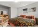Comfortable bedroom with floral bedding, a crib, and a serene atmosphere at 247 Tipple Pkwy, Frederick, CO 80530