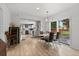 Open floor plan with dining area and kitchen views, featuring modern lighting and sleek flooring at 247 Tipple Pkwy, Frederick, CO 80530