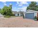 View of the house and detached garage with well-kept yard and blue skies at 247 Tipple Pkwy, Frederick, CO 80530