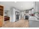 Bright and airy modern kitchen with white cabinets, stainless steel appliances, and light wood flooring at 247 Tipple Pkwy, Frederick, CO 80530