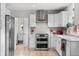 Contemporary kitchen with white cabinetry, stainless steel appliances, and stylish backsplash at 247 Tipple Pkwy, Frederick, CO 80530