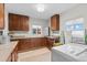 Functional laundry room features a utility sink and plenty of cabinet space for storage with natural light at 247 Tipple Pkwy, Frederick, CO 80530