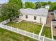 A fenced backyard with green lawn, patio, and view of the house's rear exterior at 7725 Hummingbird Green # 78, Frederick, CO 80530
