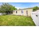 The backyard features a well maintained lawn and a white picket fence at 7725 Hummingbird Green # 78, Frederick, CO 80530