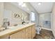 A well-lit bathroom offers a double vanity and a glass enclosed shower at 7725 Hummingbird Green # 78, Frederick, CO 80530