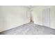 A neutral bedroom features plush carpet, closet and en-suite bathroom access at 7725 Hummingbird Green # 78, Frederick, CO 80530