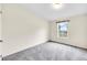A cozy bedroom features a window with bright, natural light and plush carpet at 7725 Hummingbird Green # 78, Frederick, CO 80530