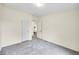 A neutral bedroom features plush carpet, closet and en-suite bathroom access at 7725 Hummingbird Green # 78, Frederick, CO 80530
