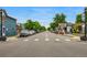 A street view in town featuring local businesses and parked cars at 7725 Hummingbird Green # 78, Frederick, CO 80530