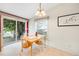 Inviting dining area with a light wood table, garden view through sliding glass doors, and bright natural light at 7725 Hummingbird Green # 78, Frederick, CO 80530