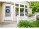 Charming home exterior featuring a white front door with a wreath and adjacent large window at 7725 Hummingbird Green # 78, Frederick, CO 80530