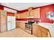 Functional kitchen featuring wood cabinets, neutral countertops, and stainless steel appliances at 7725 Hummingbird Green # 78, Frederick, CO 80530