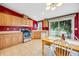 Bright kitchen with light wood cabinets, stainless steel appliances, and adjacent dining area at 7725 Hummingbird Green # 78, Frederick, CO 80530