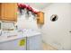 A practical laundry room with modern appliances and storage shelves at 7725 Hummingbird Green # 78, Frederick, CO 80530