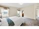 A bright main bedroom features two windows, neutral tones, and plush carpet at 7725 Hummingbird Green # 78, Frederick, CO 80530