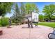 Town square view with a City Hall building, bronze statues, and flower beds at 7725 Hummingbird Green # 78, Frederick, CO 80530