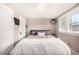 Cozy bedroom with ample natural light from the window with a comfortable queen sized bed at 2564 S Acoma St, Denver, CO 80223