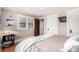 Another cozy bedroom with ample natural light from the window with a comfortable queen sized bed at 2564 S Acoma St, Denver, CO 80223