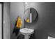 Stylish bathroom with a pedestal sink and a modern mirror at 1415 W 68Th Ave, Denver, CO 80221