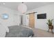 Main bedroom with barn door and large window at 1415 W 68Th Ave, Denver, CO 80221