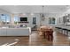 Open dining area with a wooden table and modern pendant lights at 1415 W 68Th Ave, Denver, CO 80221