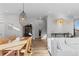 Elegant dining area with a wood table and modern light fixture at 1415 W 68Th Ave, Denver, CO 80221