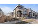 Modern three-story townhome with light-grey and dark-grey exterior at 1415 W 68Th Ave, Denver, CO 80221