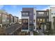 Modern townhome featuring multi-tone color scheme, balcony, and tidy landscaping at 1415 W 68Th Ave, Denver, CO 80221