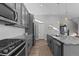 Sleek kitchen with stainless steel appliances and granite countertops at 1415 W 68Th Ave, Denver, CO 80221