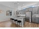 Modern kitchen with gray cabinets, granite island, and stainless steel appliances at 1415 W 68Th Ave, Denver, CO 80221