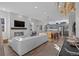 Open living room showcasing a fireplace and modern furniture, leading to a kitchen at 1415 W 68Th Ave, Denver, CO 80221