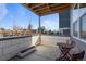 Small patio with wooden table and chairs, perfect for relaxing at 1415 W 68Th Ave, Denver, CO 80221