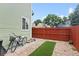 A neat backyard with a decorative rock garden, red fencing, and a charming bicycle at 8997 W 88Th Ave, Westminster, CO 80021