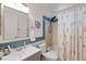 Inviting bathroom equipped with a tub and shower, complemented by a floral shower curtain and modern fixtures at 8997 W 88Th Ave, Westminster, CO 80021