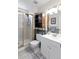 Modern bathroom featuring a glass-enclosed shower, ample shelving, and a sleek vanity at 8997 W 88Th Ave, Westminster, CO 80021