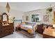 Charming bedroom bathed in natural light with unique decor, a cozy bed, and ample storage at 8997 W 88Th Ave, Westminster, CO 80021