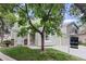 Two-story home with an attached two car garage, neutral exterior and a lovely front yard and mature tree at 8997 W 88Th Ave, Westminster, CO 80021