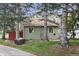 Back of home with mature trees, grass, and green siding at 8997 W 88Th Ave, Westminster, CO 80021