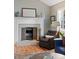 Close up of the fireplace in the living room with hearth and accessories, with seating nearby at 8997 W 88Th Ave, Westminster, CO 80021