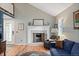 Charming living room with a fireplace, bright windows, hardwood style floors and an adjacent staircase at 8997 W 88Th Ave, Westminster, CO 80021