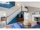 Cozy living room featuring a fireplace, a staircase to the second floor and hardwood style floors at 8997 W 88Th Ave, Westminster, CO 80021