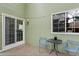 A comfortable patio area features sliding glass doors, a window, and cozy outdoor seating at 8997 W 88Th Ave, Westminster, CO 80021