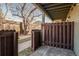 Covered patio with wooden fence surrounding a small yard at 1885 S Quebec Way # A16, Denver, CO 80231