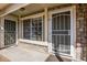 The entrance with secure doors and a small concrete patio at 1885 S Quebec Way # A16, Denver, CO 80231
